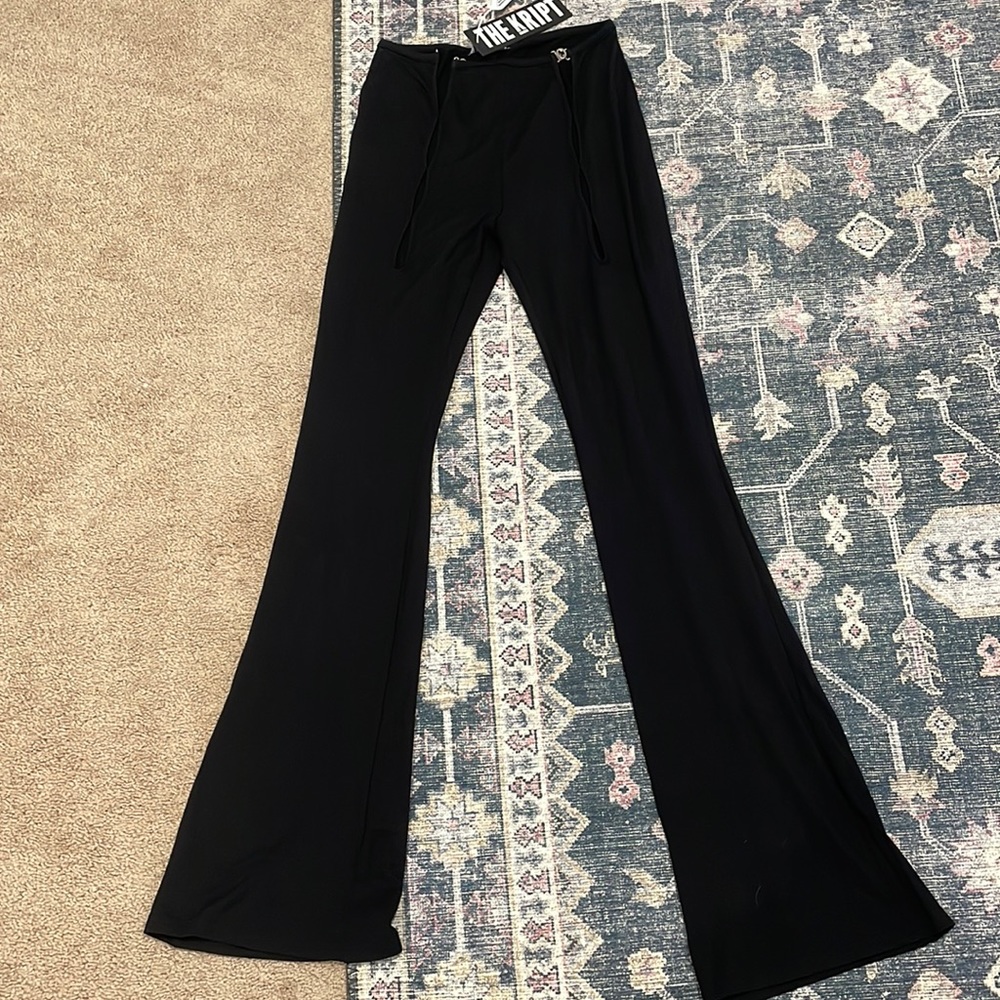 The Kript brand new black flowy leggings with a open design on the front.
